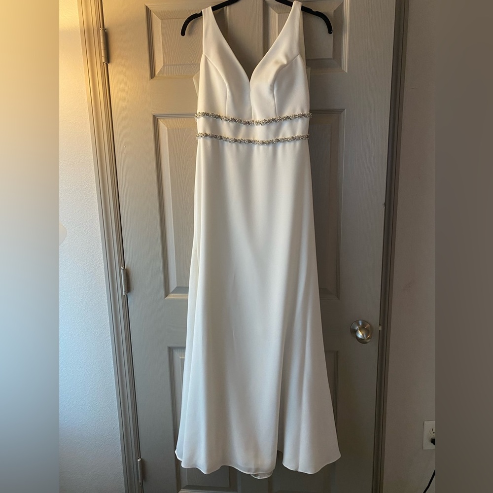 Long white formal gown. Low V-neck. Size 4. Light tan mesh sides. Custom cut.